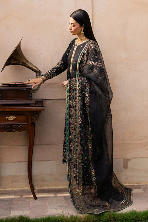 NAQSHI Gul-e-Tesnim side pose – showcasing structured silhouette and full sleeve embroidery in black silk
